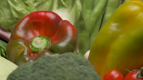 Red pepper and various mixed vegetables rotating. Typical Mediterranean diet, vegan or vegetarian nu