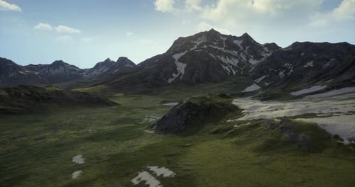 Majestic Mountain Landscape with Rolling Green Hills and Snow Capped Peaks