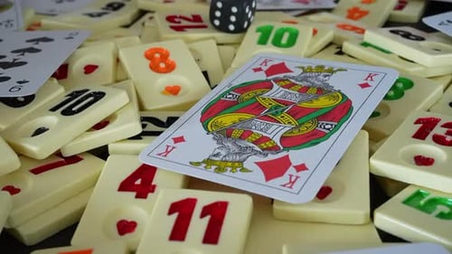 Cards and Rummy Tiles with Die Scattered