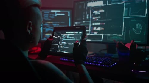 Focused Female Hacker Checks Work of Software on Tablet