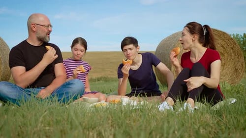 Family Picnic in the Countryside Eating Sandwiches