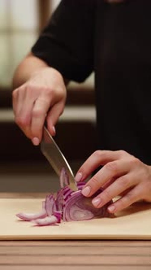 Slicing a Red Onion on Cutting Board