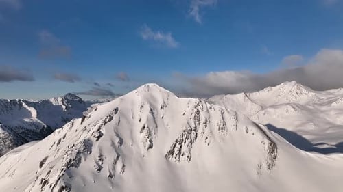 Aerial footage of a winter mountain landscape.