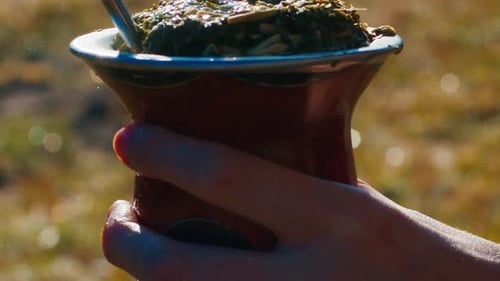 Person Pours Hot Water in the Mate Drink Being Outdoor