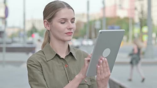 Woman Using Tablet in the City