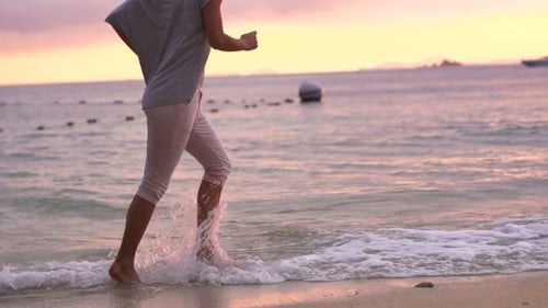 Woman Jogging During Beautiful Sunset on Beach Active