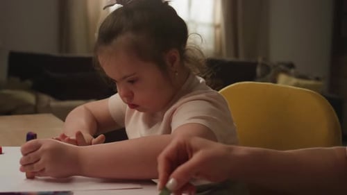 Child Drawing With Chalk Crayons With Adult