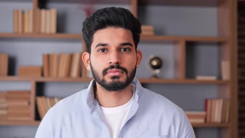Serious Looking Latin Spanish Man is Posing for a Portrait in an Office