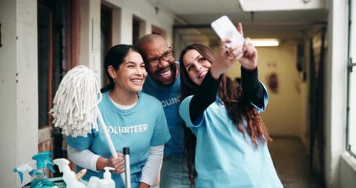 Smiling Volunteers Taking Photo Together Indoors