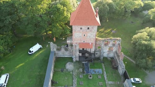 Medieval Chudow castle with a walls, tower, and courtyard during a beautiful summer day surrounded b