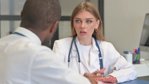 Close up of Female Doctor Discussing Report with Patient