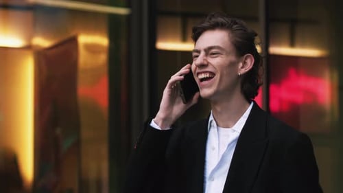 Smiling Man Talking on Phone Celebrates Success