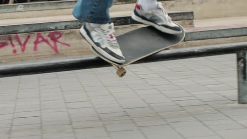 Young Skater Making 360 Flip Jump Performing Kickflip Trick Skateboarder Training in Skatepark