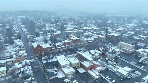 Snow storm in American town. Aerial establishing shot of small town in USA covered in snow. Blizzard
