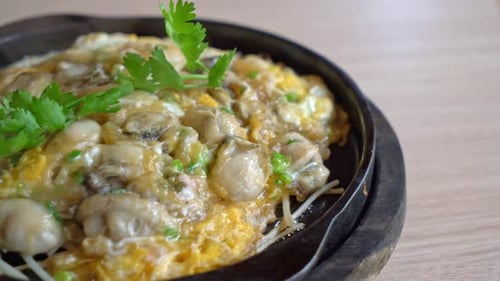 Oyster omelette with bean sprout on hot pan - Asian food style