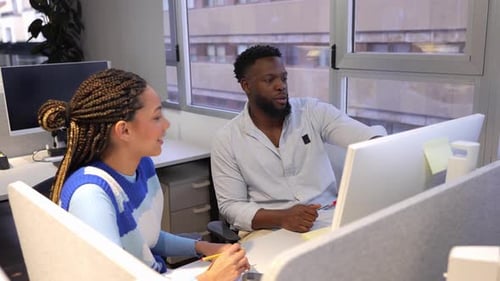 Coworkers Collaborating on Computer in Slow Motion