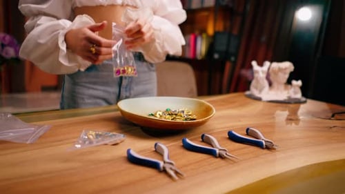 close-up female hands pouring out beautiful beads for a necklace or earrings the beauty of jewelry