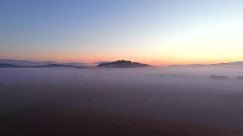 Aerial View of Sunrise Landscape with Thick Morning Fog and Golden Light