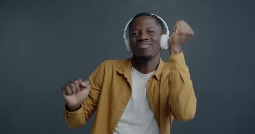 Young Adult Dancing and Listening to Music