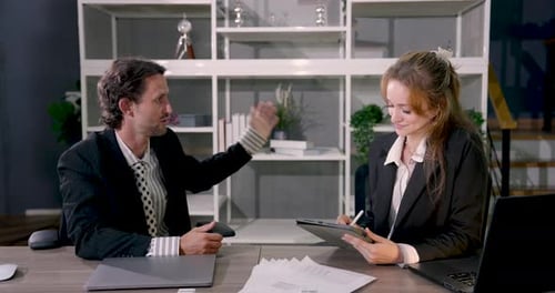 Multiracial business partners having positive conversation during office meeting smiling and sharing