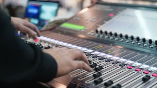 Hand of the Sound Producer. Professional Audio Operator Working on Audio Mixer