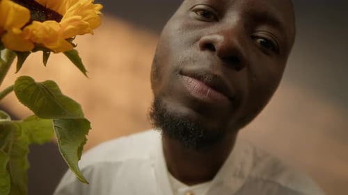 Closeup of Black Man with Sunflower Studio Portrait