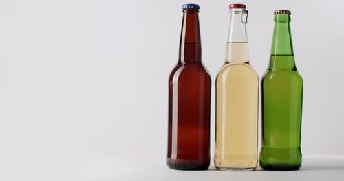 Three Bottles of Beer Lined Up on Table