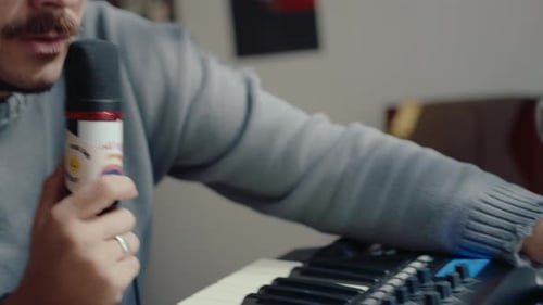 Musician in Headphones Recording a Song in Home Studio
