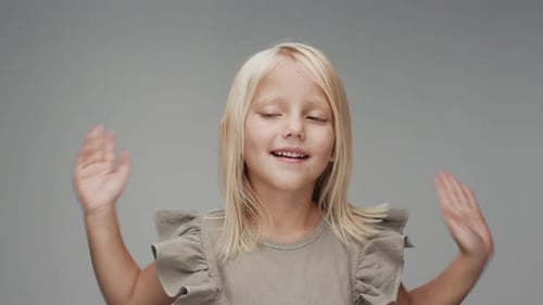 Happy Girl Covers Eyes and Smiles