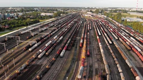 Aerial shot Showing Large Train Depot With Many colorful cargo Trains