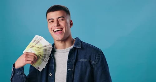 Man Holding Money and Laughing