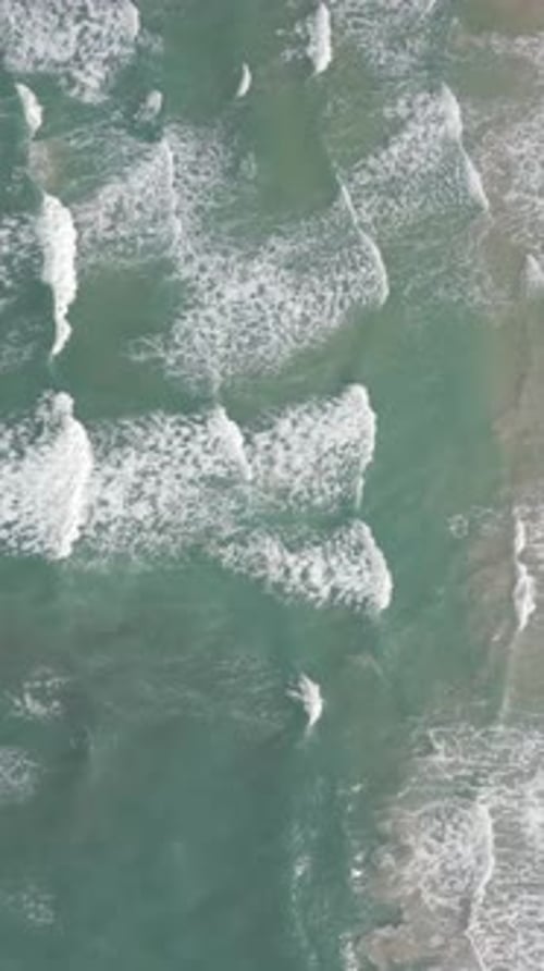 Mesmerizing View of Ocean Waves and White Foam Creating Stunning Spectacle