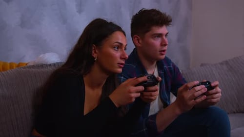 Young Adults Playing Video Games on Couch