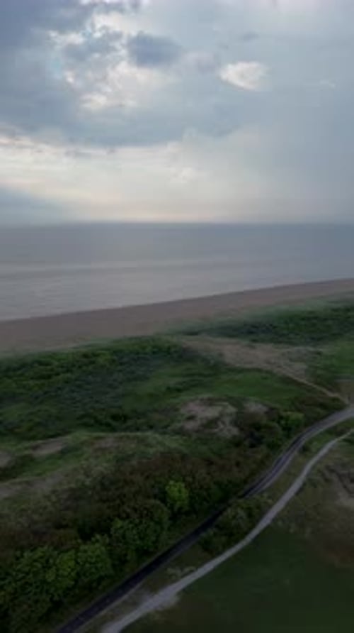 A beautiful bike path shot from above. Flying a quadcopter over a bike path. Green grass and bushes