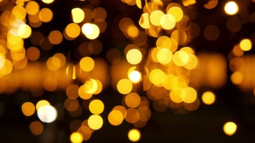 A Lot of Small Golden Lights on a Black Background the Lights are Blurry