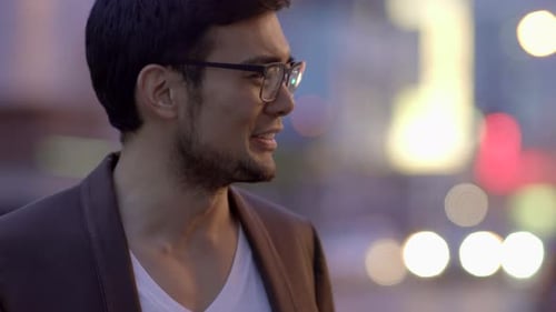 Young Adults Chatting on City Street at Night