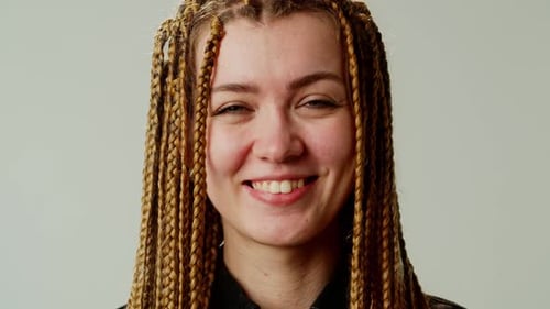 Smiling Young Woman with Blonde Braided Hair
