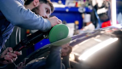 the Car Mechanic at a Service Station Doing the Final Polishing to Shine