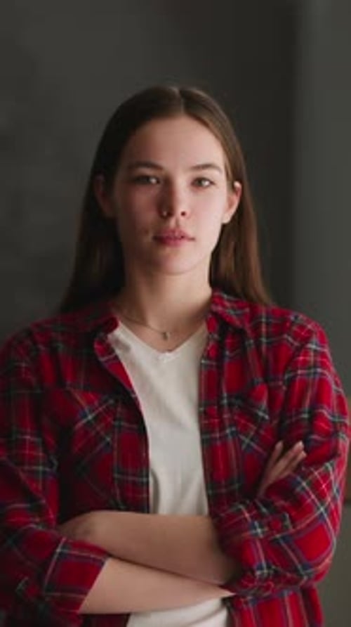 Young Woman Smiling with Arms Crossed Indoors