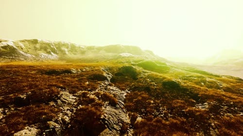 A Scenic Landscape with Mountains in the Background and a Lush Grassy Area