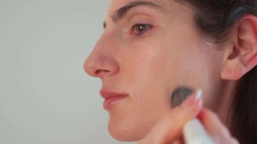 Beautician Applying Face Makeup on Woman Using Cosmetic Brush