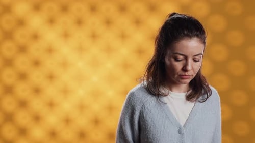 Retrato de mulher radiante posando sentindo-se feliz no fundo do estúdio