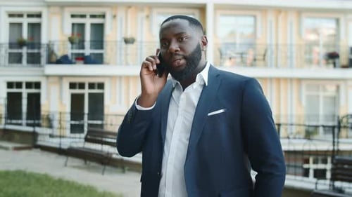Man in suit talking on cell phone outside