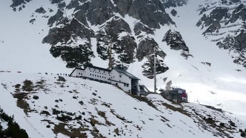 Cable car station at the Nordkette mountain on a partly sunny day in winter time. Wide shot