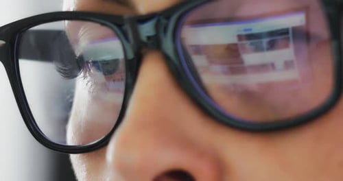 Man Wearing Glasses with Screen Reflection Close Up