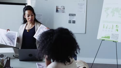 Environmental scientist explains topographic map strategy in office meeting