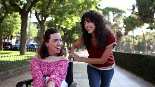 Friends Laughing on a Park Walkway