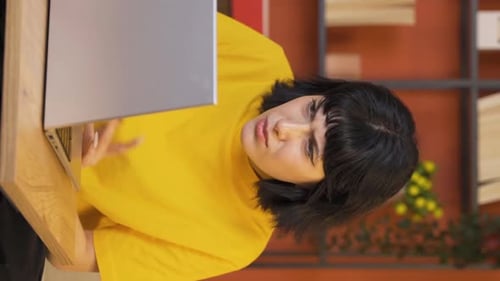 Woman Typing on Laptop in Office Interior