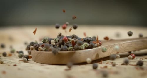 Mixed peppercorns in a super slow motion. Dry mix peppercorns close up.