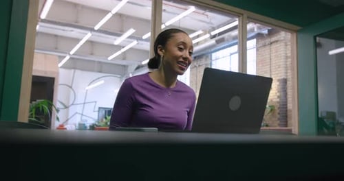 Cheerful Woman in Meeting using Video Call technology in Office